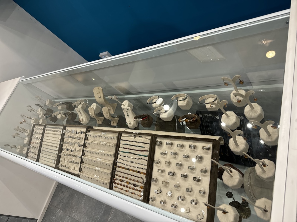 Display case of silver rings, bracelets and earrings